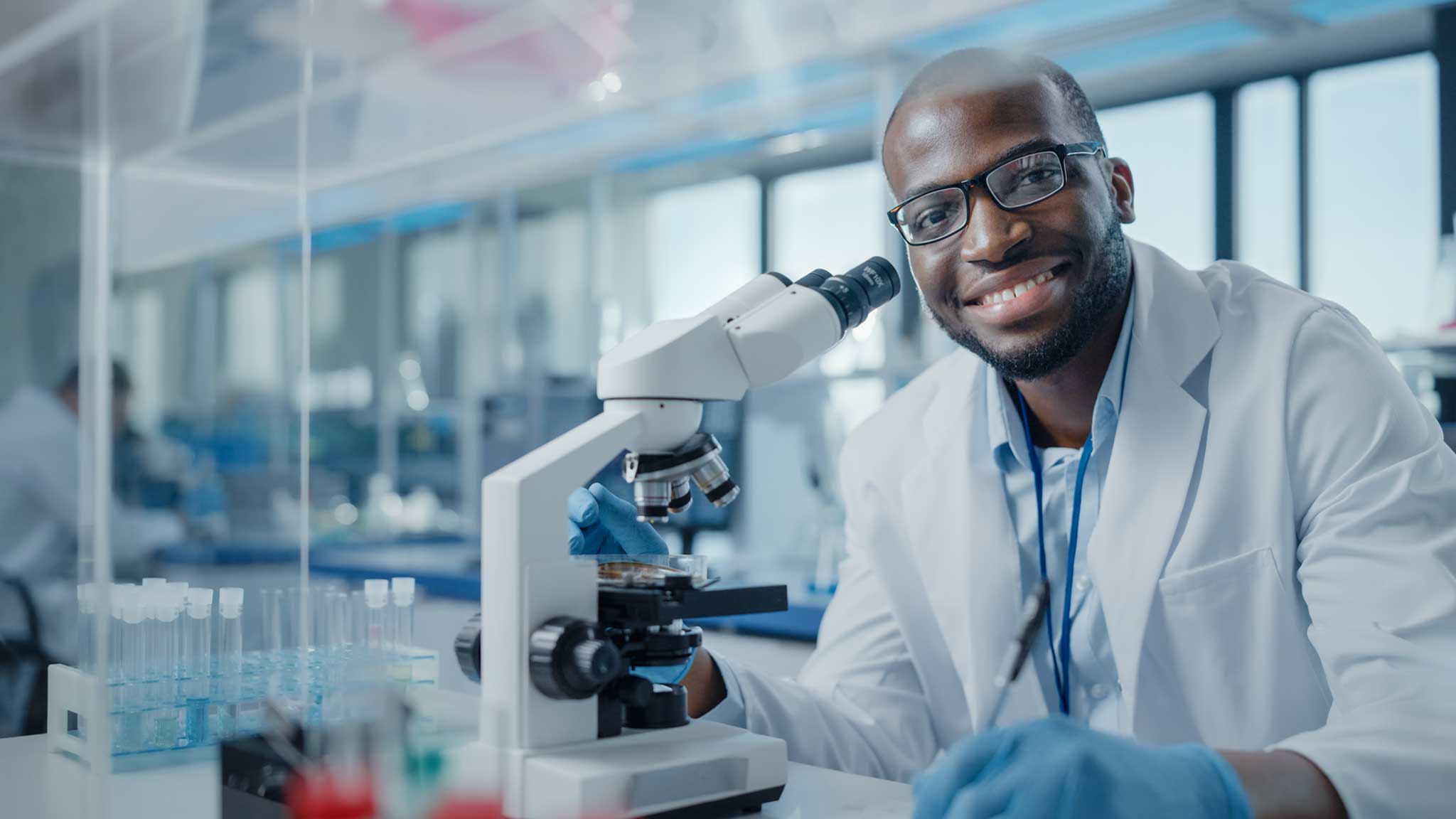 scientist at a microscope