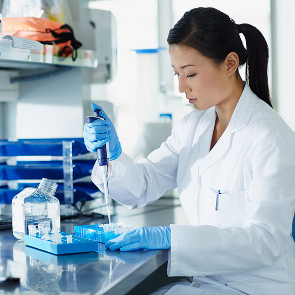 female scientist pipetting in a lab